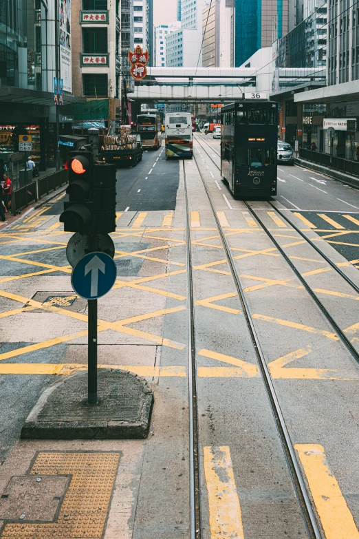 cars and trolleys line the street near a crossing