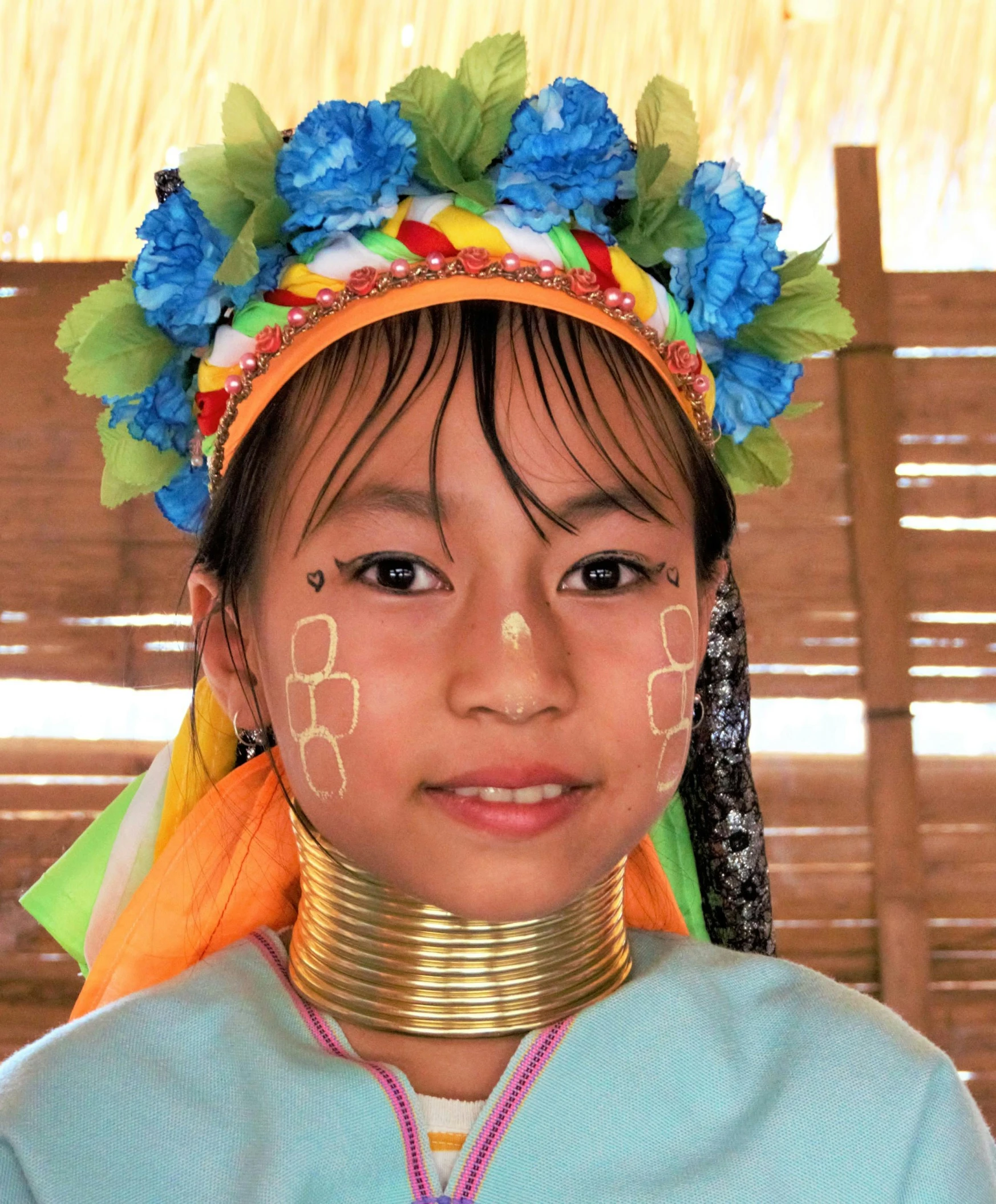 a young asian girl wears the colorful choker and flower headdress