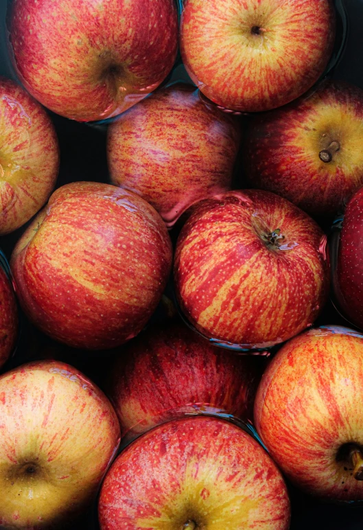 an array of apple's in front of a black background