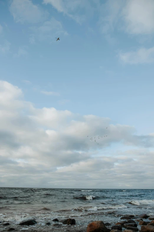 a airplane flies through the air above the ocean