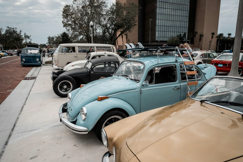 several classic cars parked along side each other