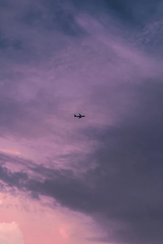 a plane flying through a cloudy sky at night