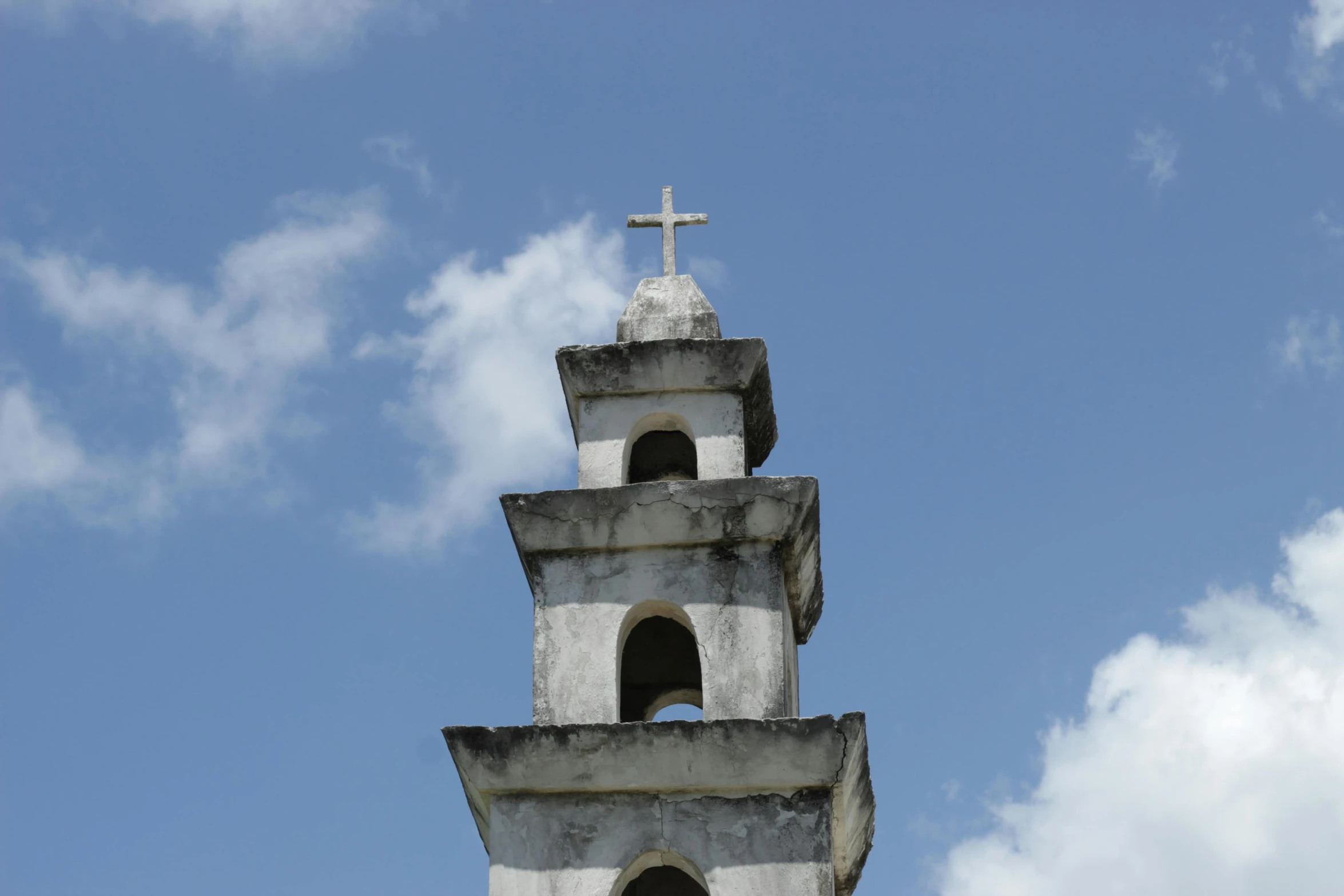 a bell tower with a cross on the top