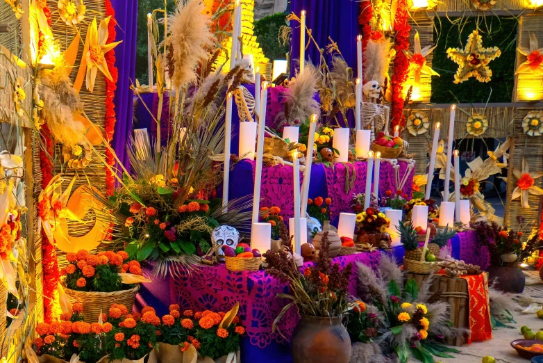 large pots with candles and flowers set on a table