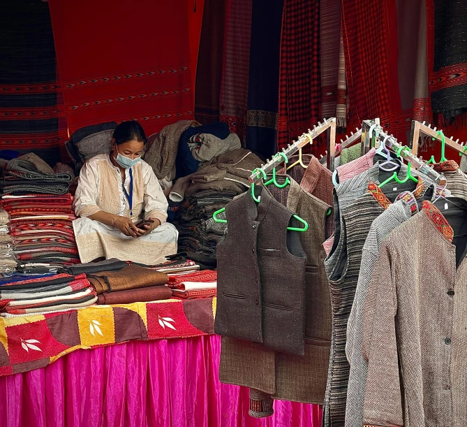men sitting on a stage at an oriental clothing store