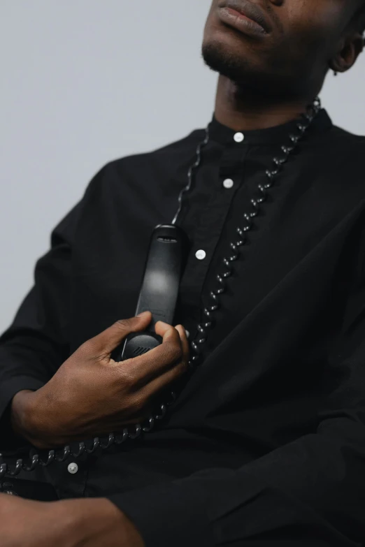 a man in black shirt holding an electronic device