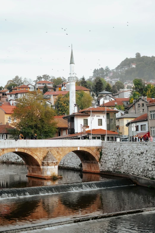 an old bridge and village are in the background