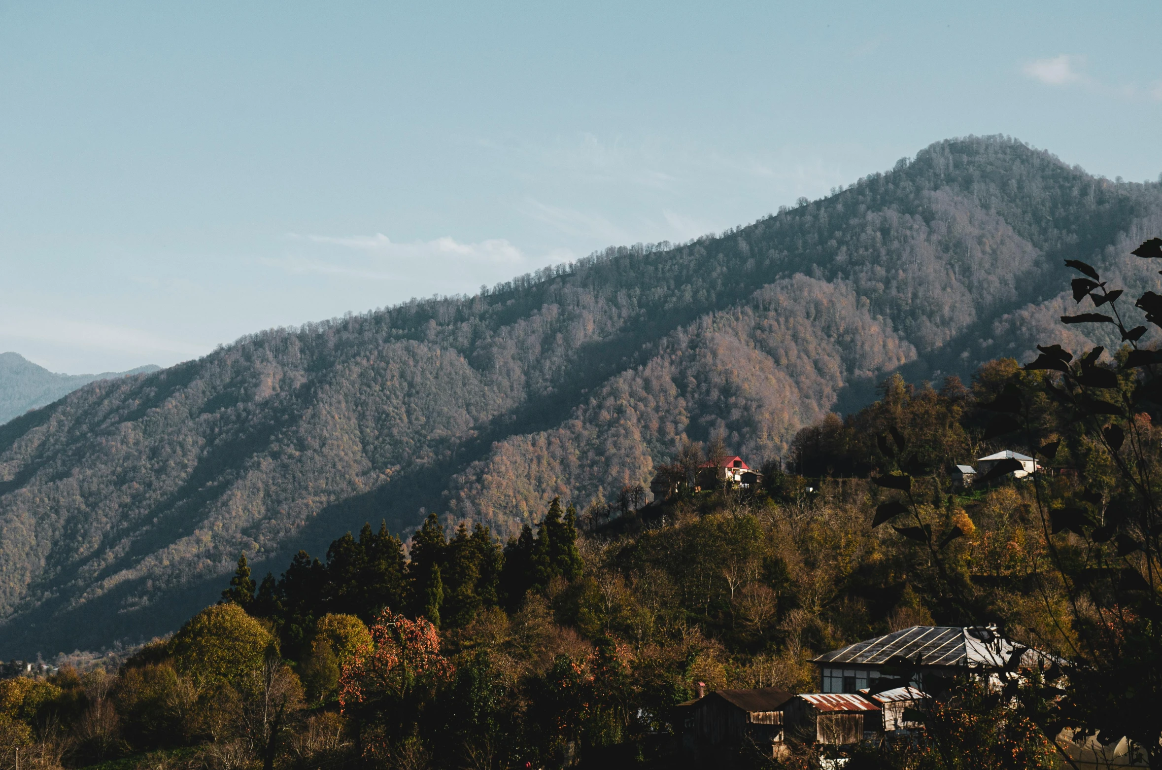 a mountain with a white house near by