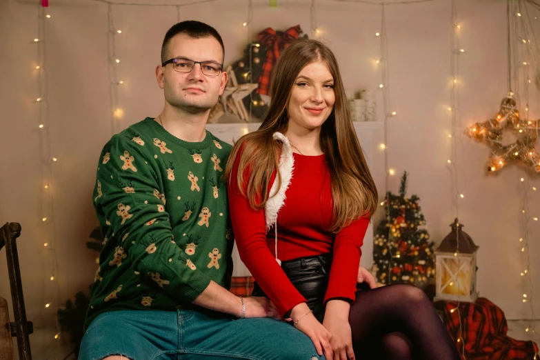 two people are sitting on a couch in front of lights