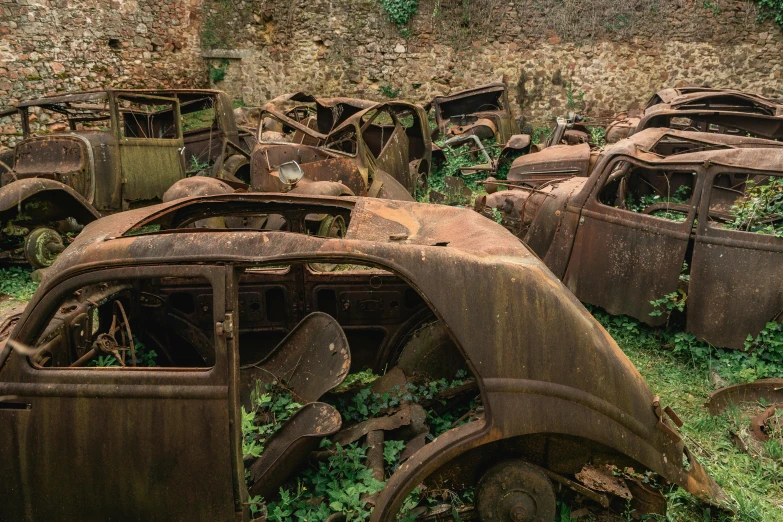 an old and rusty automobile with grass growing on top