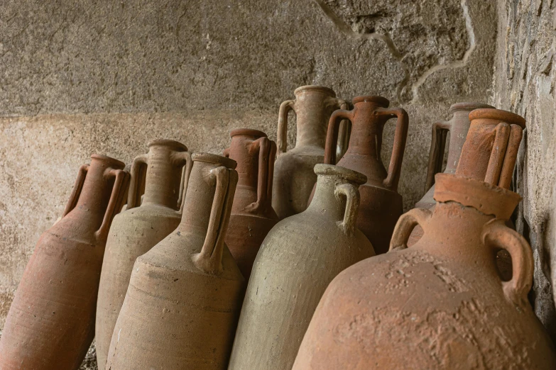 large pots in the corner of a brick building