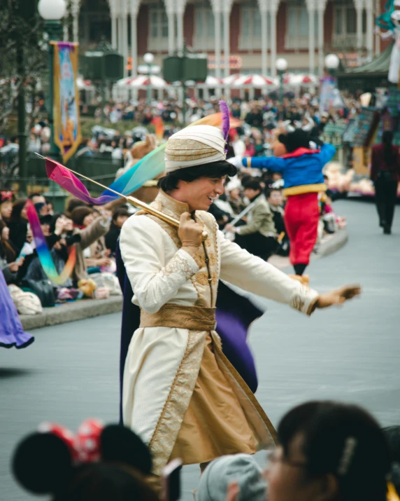 a lady holding up a flag at the end of an outdoor parade