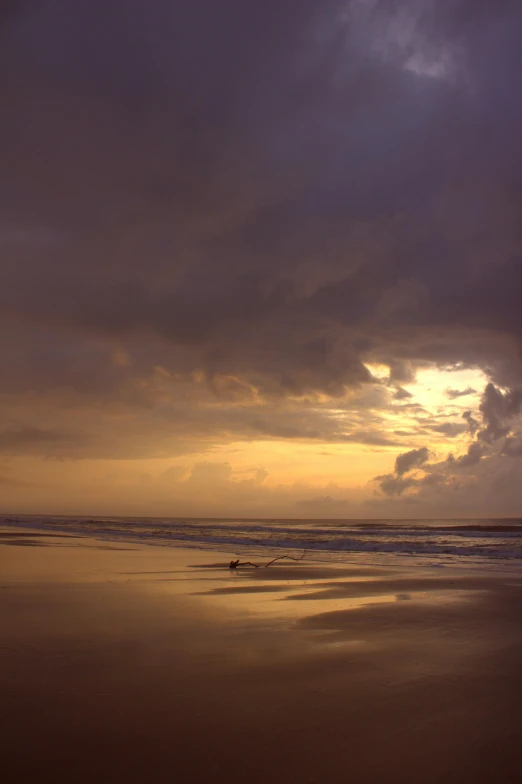 the sun sets over a beautiful beach and water