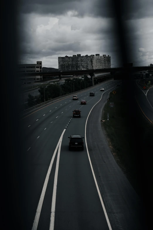 traffic on a freeway with dark cloudy skies