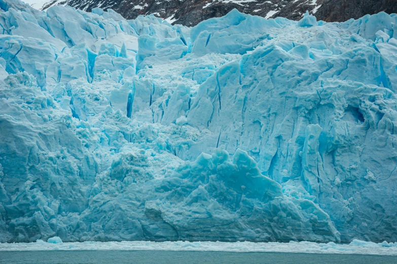 an image of glacier walls on the side of a lake