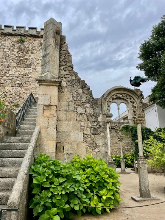 a staircase leads up to an ancient brick building