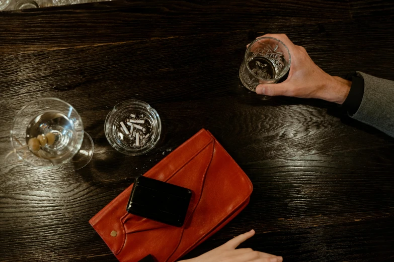 a person is opening a wine glass in front of a card case