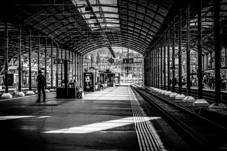 black and white image of an empty train station