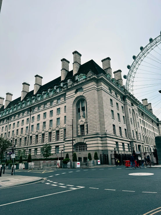 a large old building with a ferris wheel on the outside