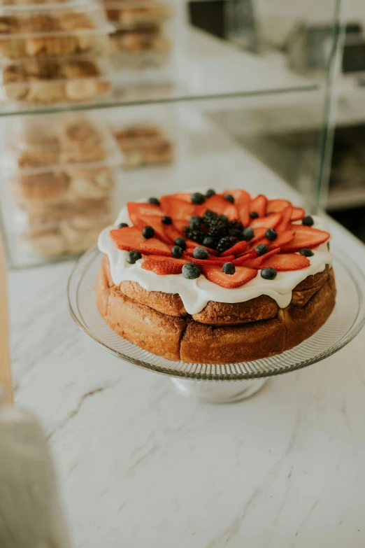 small cake sitting on a glass stand