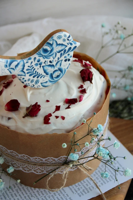 a white cake topped with frosting and red roses