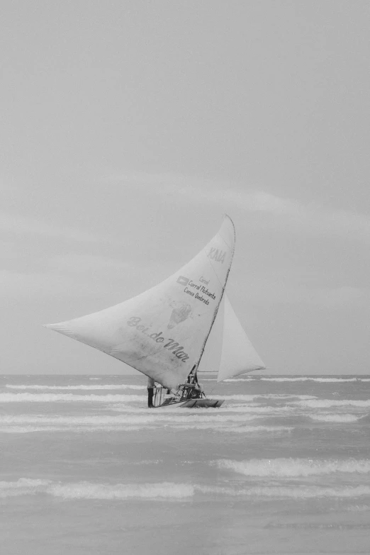 a black and white po of two people on a sail boat