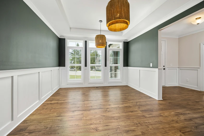 a empty room with large open windows and green walls