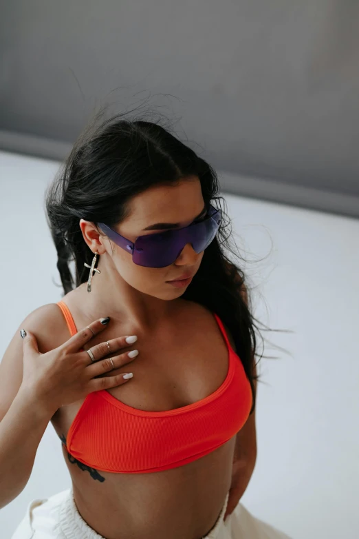 a woman is wearing sunglasses and is posing for a po