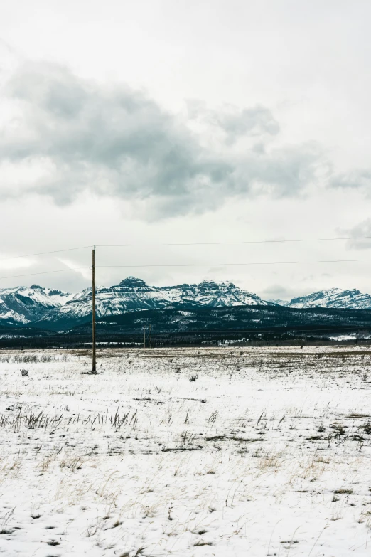 a po of snow and a few hills in the distance