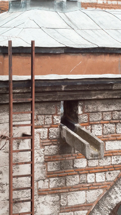 an outside view of a building with pipes and roof