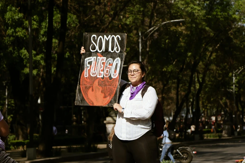 a smiling woman holding a sign for frisbee