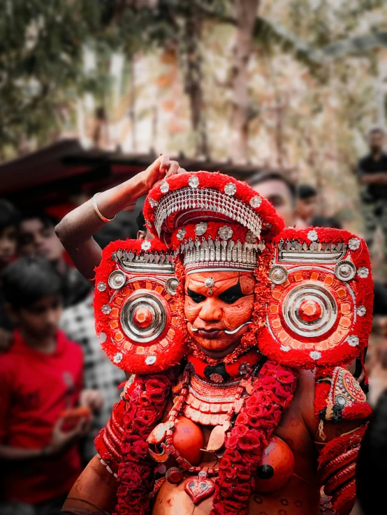 a man in an elaborate headdress is dancing