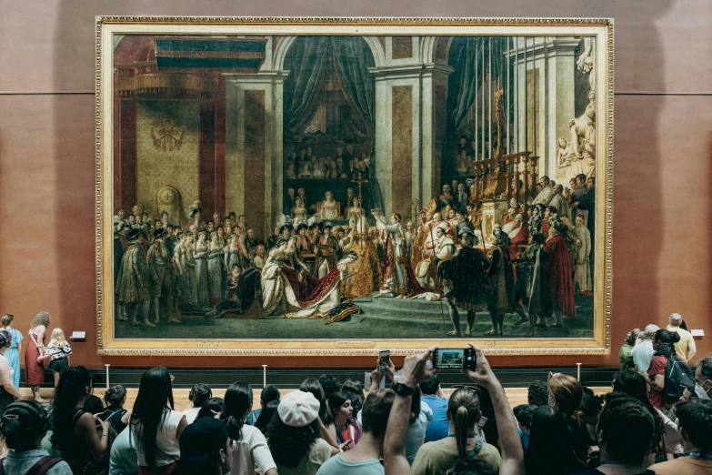 a painting on display with people taking pictures of it