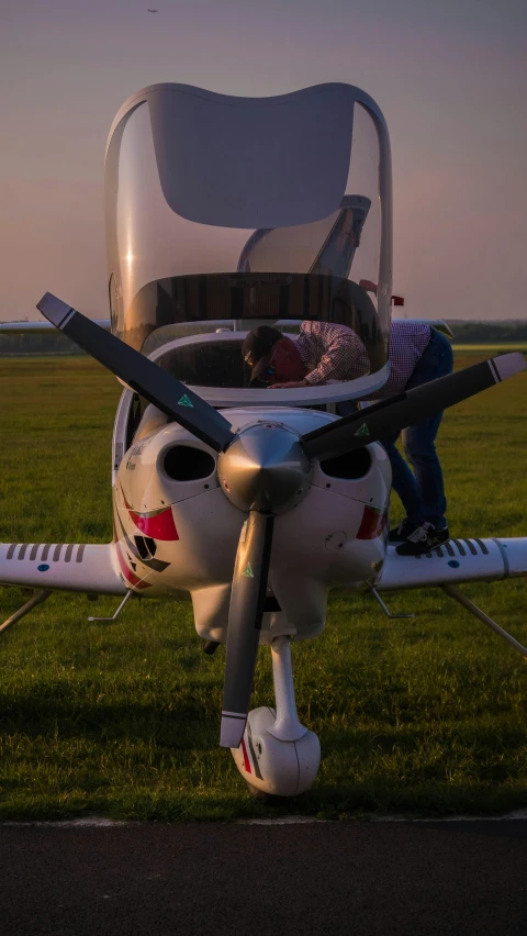 a small plane on an airfield with passengers inside it