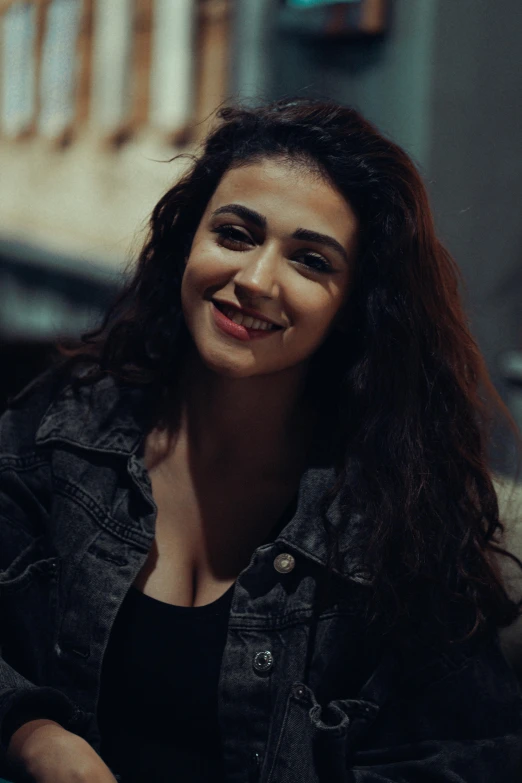 a woman smiling while sitting down