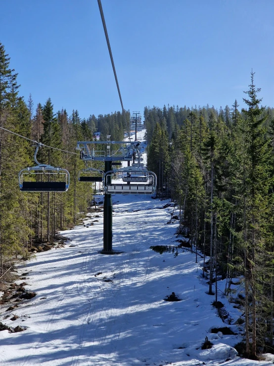 a snow covered mountain slope with a ski lift