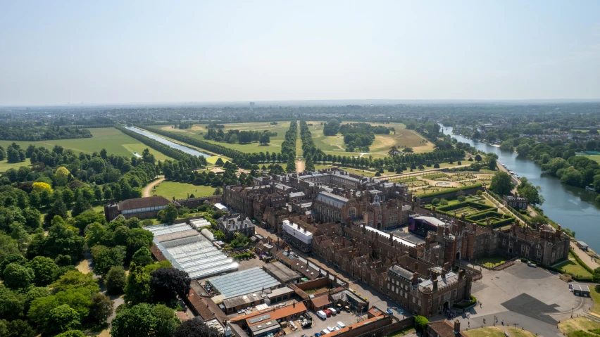 an aerial view of a historic building next to a river