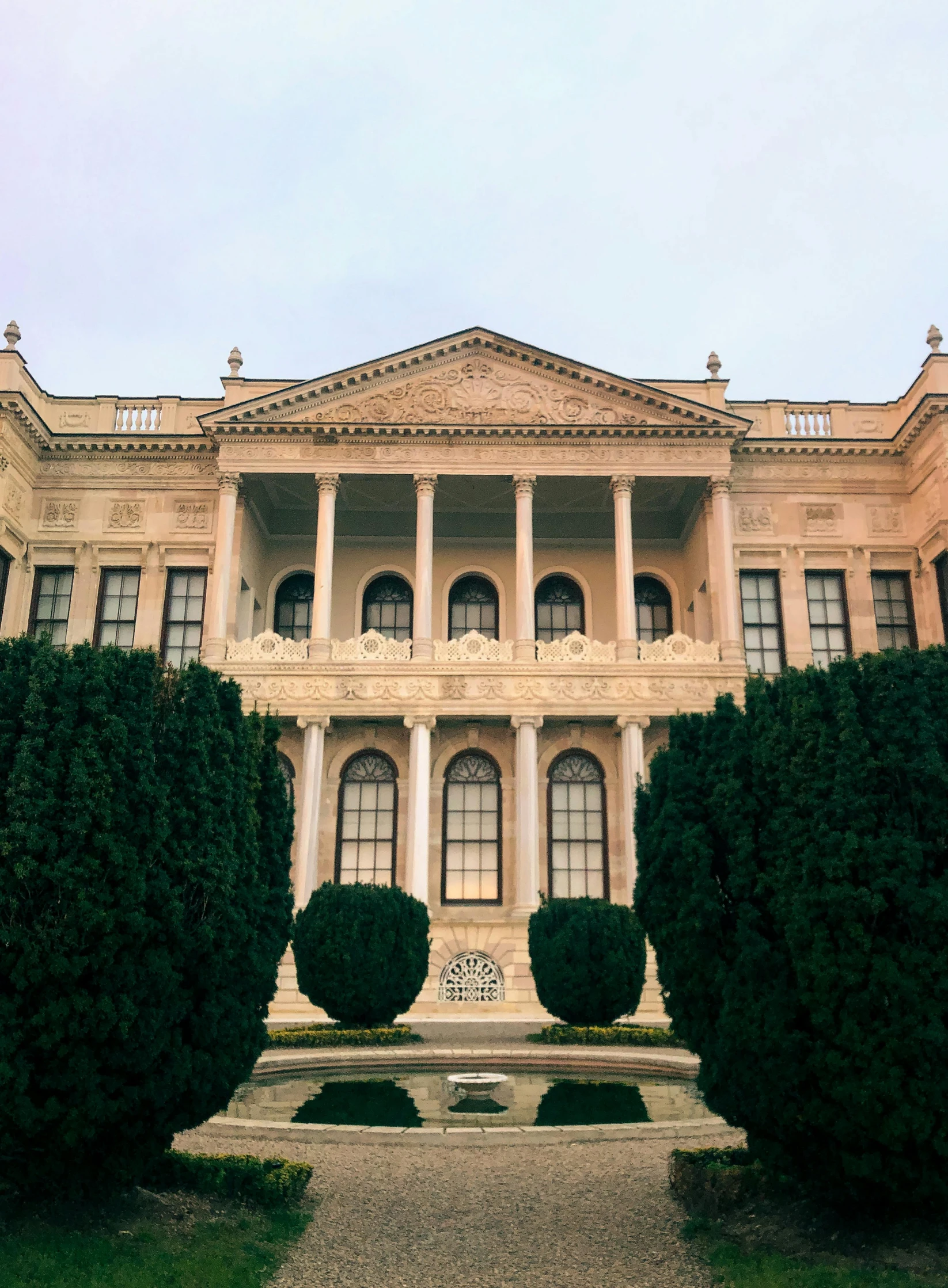 a building has several tall hedges in front