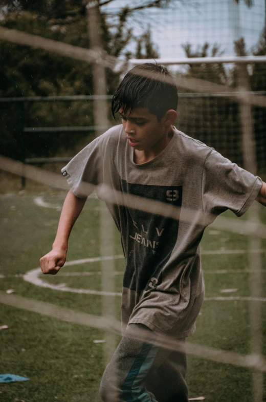 a young man is kicking the soccer ball