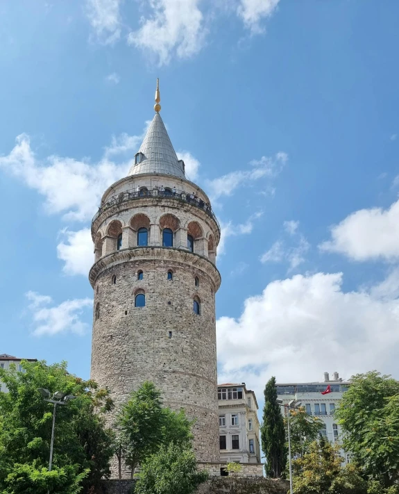 a tall tower surrounded by trees and buildings