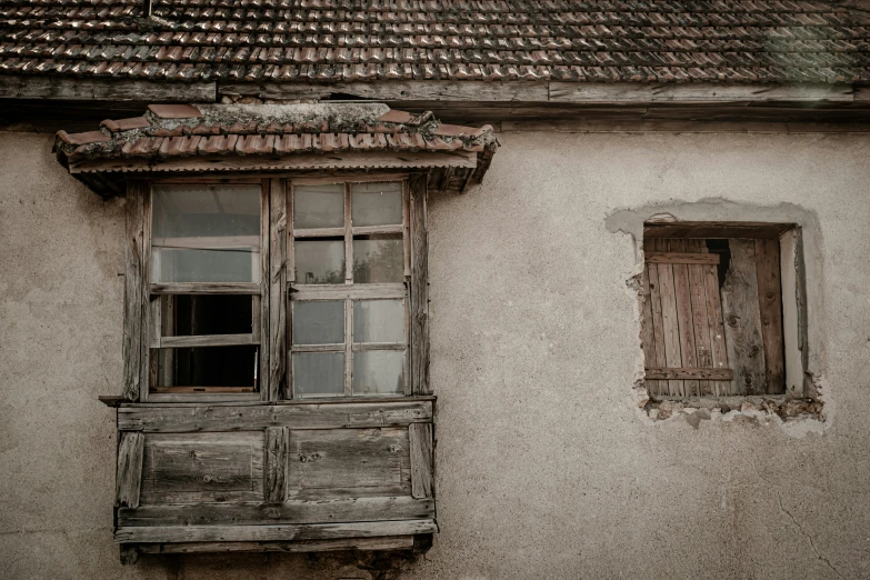 an old window with shutters on the side of a white building