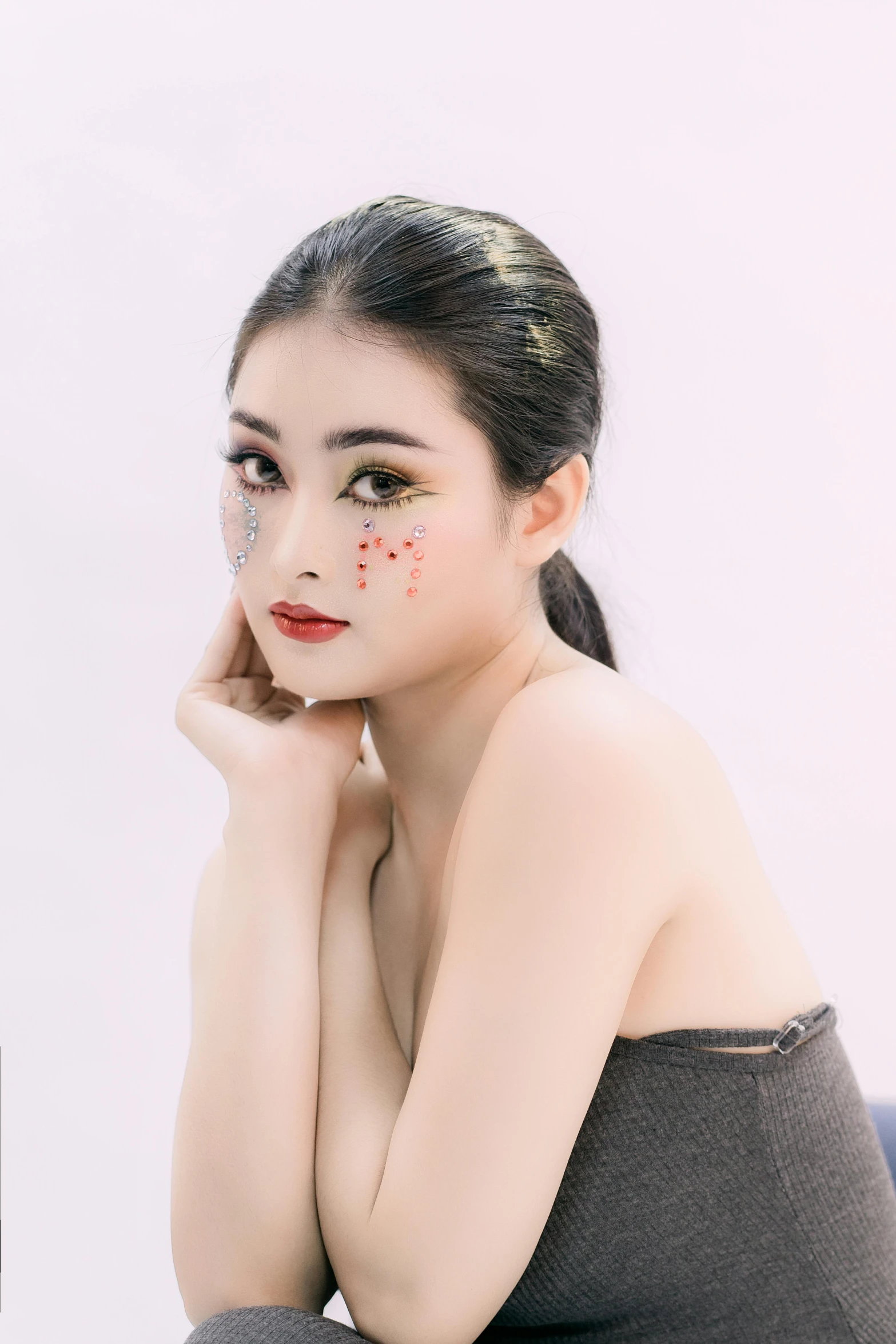 an asian woman posing with white paint on her face and hands