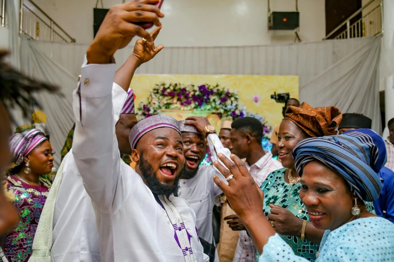 several people taking a selfie at a function