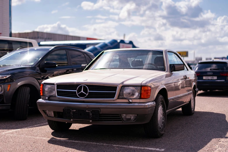 several mercedess are parked at the airport and there is only one car