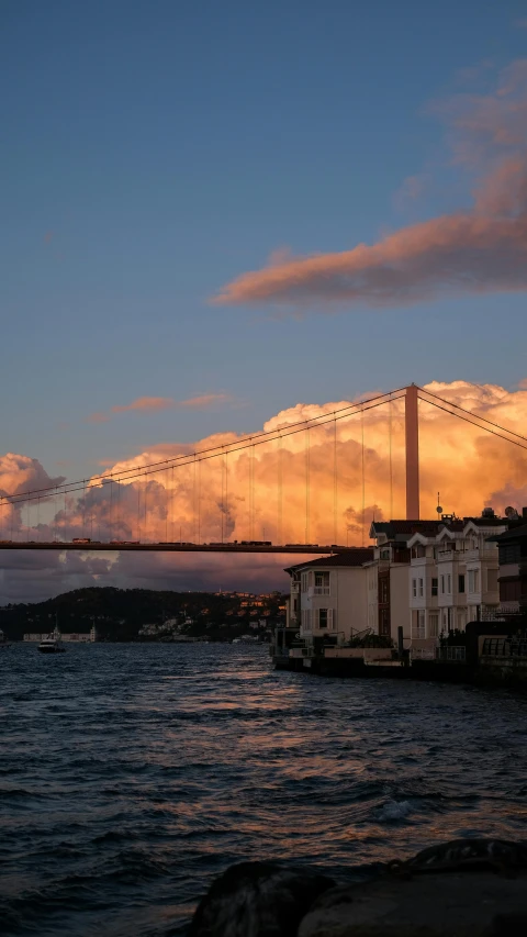 a long bridge stretching over the water in the evening