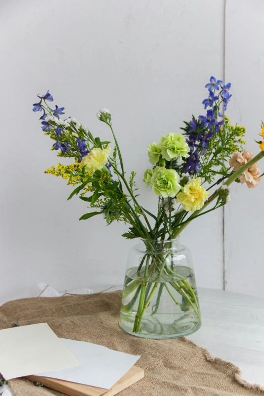 a vase filled with different kinds of flowers