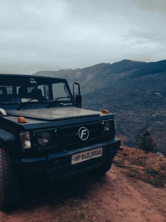 the truck is driving on the trail up the mountain