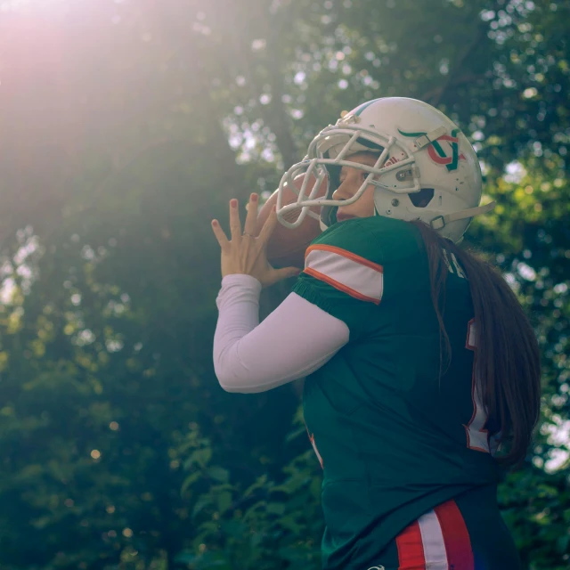 a person in a helmet has a ball in the air