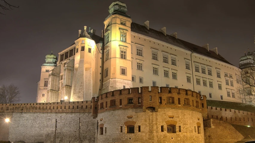 a tall, historic building lit up at night