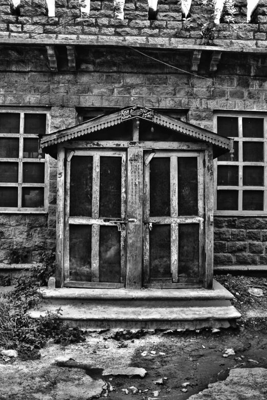 a small wooden shrine in front of a brick building